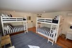 Spacious bunk room with two bunks, both with additional twin trundles